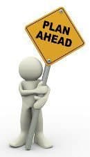 White cartoon man carrying a plan ahead road sign